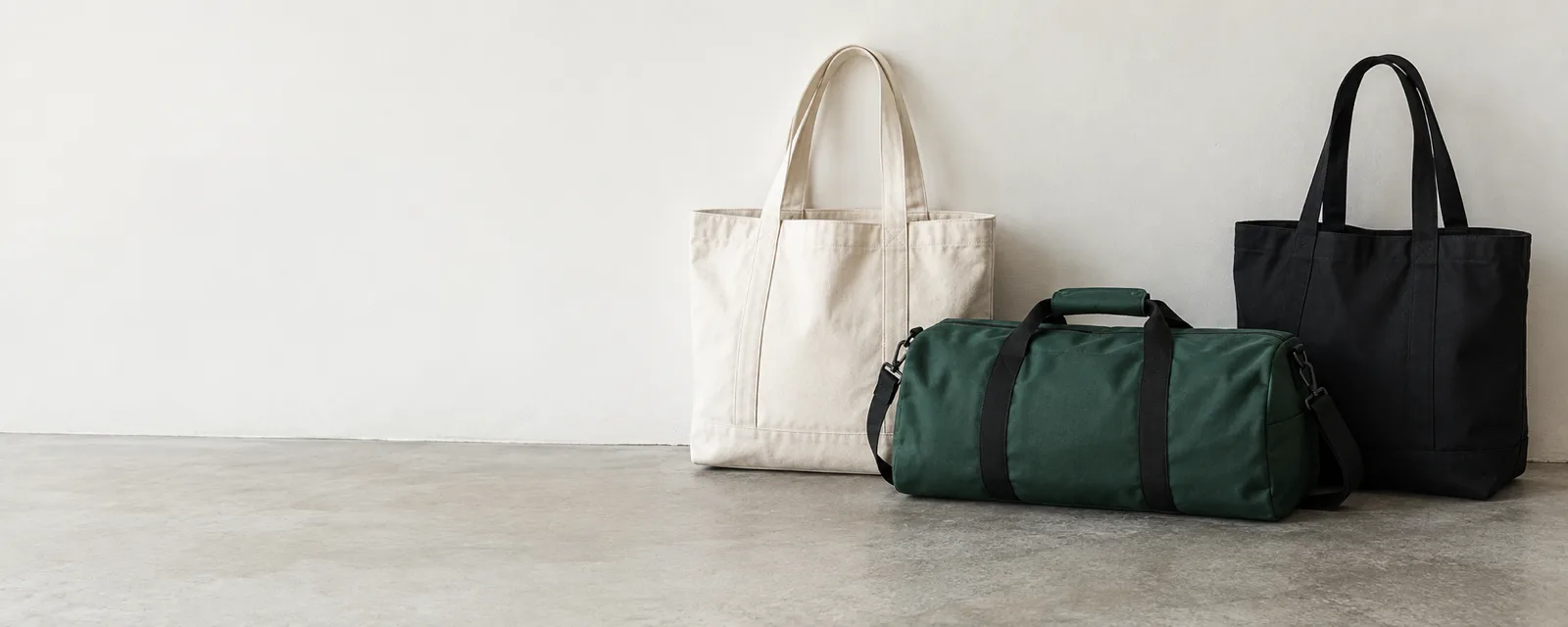 Canvas totes, a green duffel and black bags