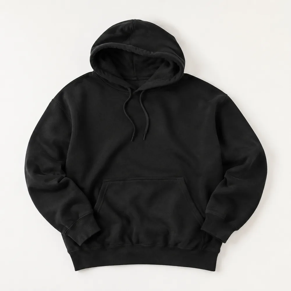 Black heavyweight pullover hoodie laid flat on an off-white background