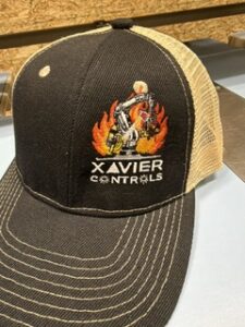 Brown and tan trucker cap embroidered with the Xavier Controls logo