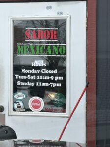 Window graphics with opening hours for Sabor Mexicano