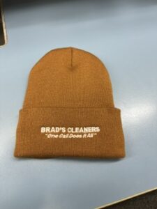 Tan cuffed beanie embroidered for Brad's Cleaners