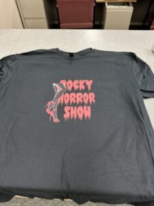 Grey tee printed with a Rocky Horror Show design