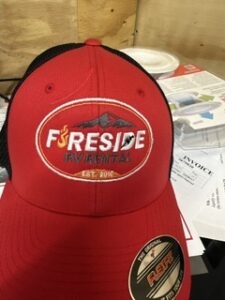 Red cap embroidered with the Fireside RV Rental logo