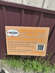 Fireside RV Rental sign mounted on a metal building