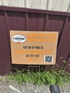 Rent an RV from us sign with QR code on a metal wall