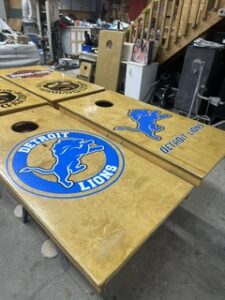 Detroit Lions cornhole boards on the bench