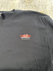Dark polo with a small embroidered logo on the chest