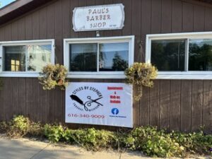 Paul's Barber Shop and Styles by Stephie signs on the building