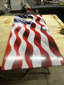 American flag cornhole board on wood