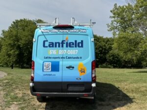 Rear doors of the Canfield van with logo, phone number and QR code