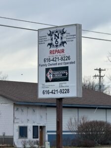 Z's Towing hanging sign with phone numbers