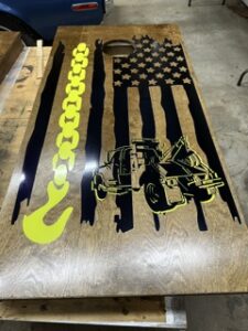Cornhole board with a distressed flag and tow hook design