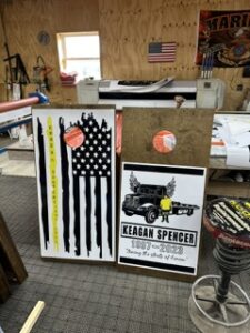 Assorted cut signs and flag panels on the workshop wall