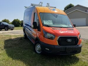 Front three-quarter view of the wrapped Canfield van